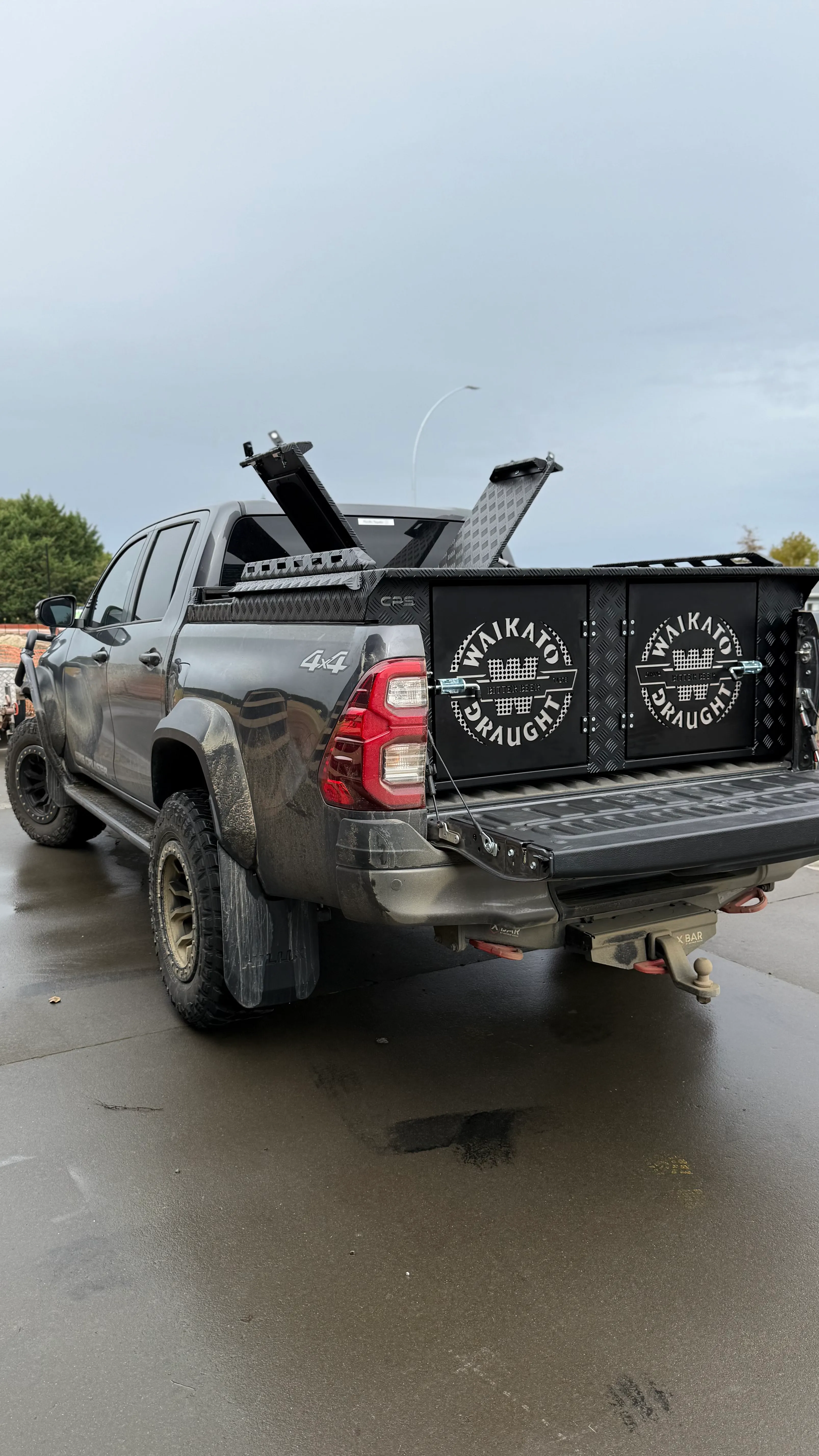 Custom black dog box installed on a grey ute